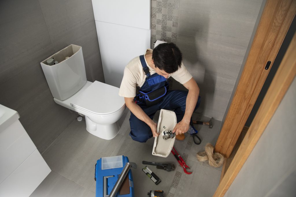 male-plumber-working-fix-problems-client-s-house-scaled.jpg