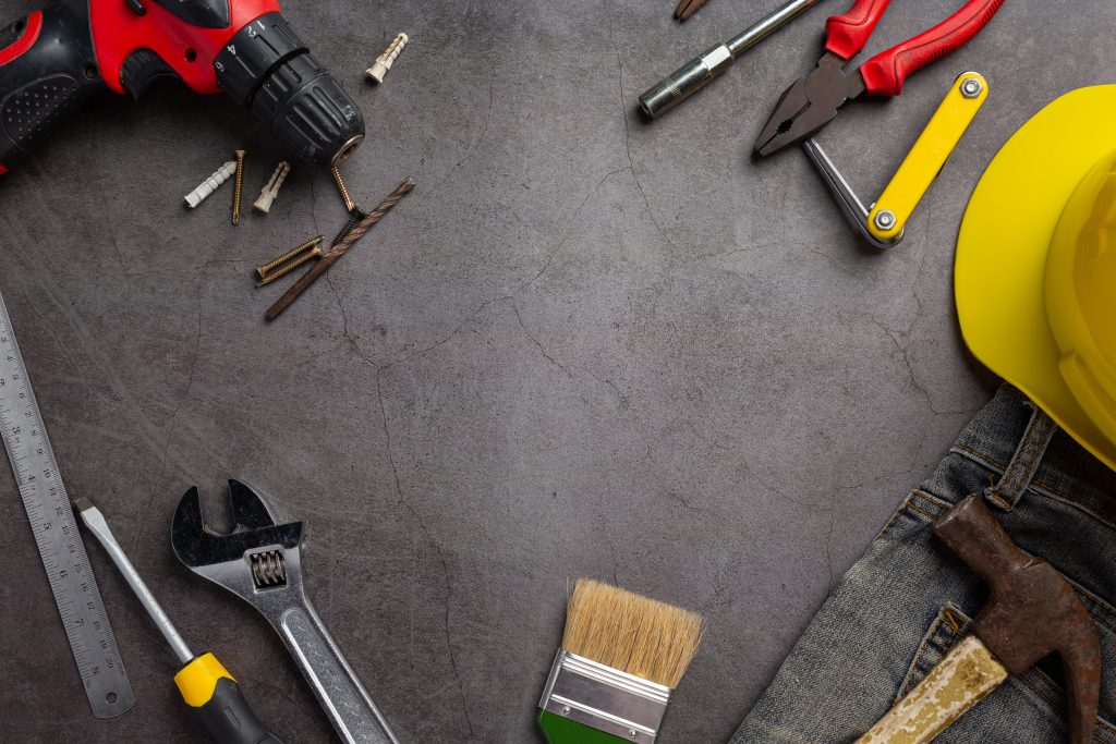 Tools on a dark background for handyman services
